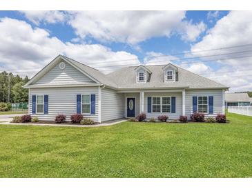 One-story house with gray siding, blue shutters, and a well-manicured lawn at 268 Maple Oak Dr., Conway, SC 29526