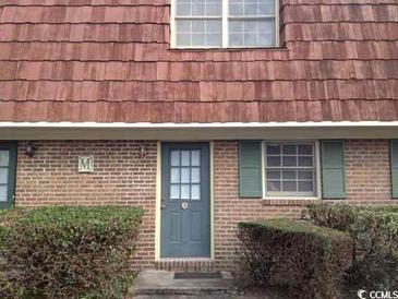 Brick building with a gray door and green shutters at 1025 Carolina Rd. # M-3, Conway, SC 29526