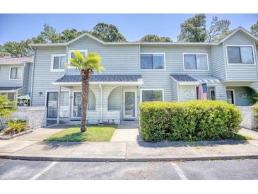 Attractive two-story townhome with landscaping and a walkway at 47 Shadow Moss Pl. # 47, North Myrtle Beach, SC 29582