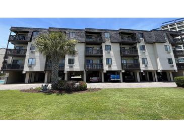 Three-story building exterior with balconies and parking at 201 76Th Ave. N # C3, Myrtle Beach, SC 29572