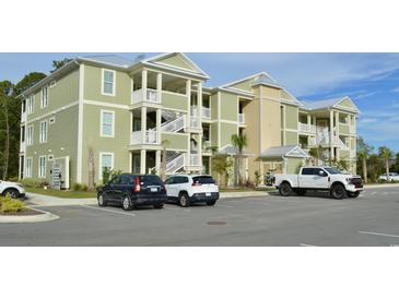 Two-story apartment building with ample parking and landscaping at 35 Delray Dr. # 2-C, Murrells Inlet, SC 29576