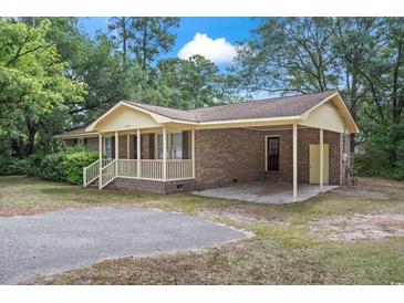 Brick ranch home with carport, mature trees, and a spacious yard at 2183 Highway 544, Conway, SC 29526