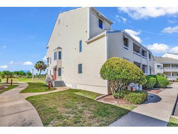 Well-maintained building exterior with landscaping and walkway at 1100 Possum Trot Rd. # C-101, North Myrtle Beach, SC 29582