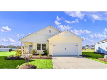 Beautiful yellow and white exterior of a new home with a two-car garage and landscaping at 3059 Deerberry Place, Longs, SC 29568