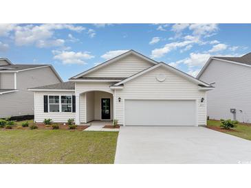 New construction home with a two-car garage and landscaped yard at 352 Clear Lake Dr., Conway, SC 29526