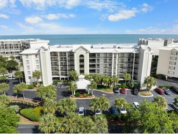 Aerial view of oceanfront condo building and parking at 669 Retreat Beach Circle # C2G, Pawleys Island, SC 29585