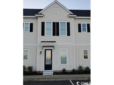 Front view of a light-colored townhome with black shutters and door at 2810 Cook Circle # D, Myrtle Beach, SC 29577