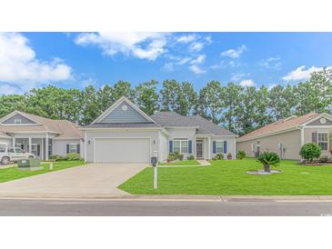 Gray house with a white garage door and blue shutters at 1616 Sapphire Dr., Longs, SC 29568