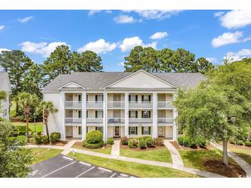 Three-story building with multiple balconies and ample parking at 5040 Windsor Green Way # 302, Myrtle Beach, SC 29579