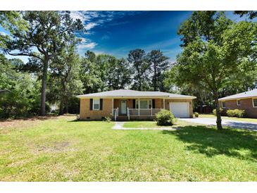 Brick ranch home with a front porch and attached garage at 553 Martin Luther King Rd., Pawleys Island, SC 29585