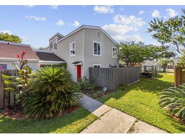 Two-story townhome with red door, landscaping, and fenced backyard at 800 9Th Ave. S # T-4, North Myrtle Beach, SC 29582