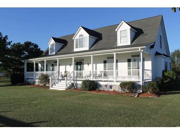 White farmhouse with large front porch at 1409 Arbor Rd., Loris, SC 29569