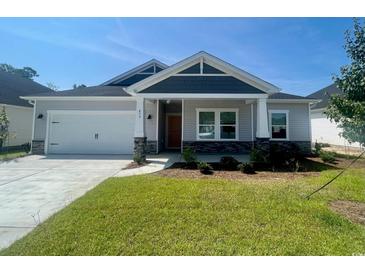 House exterior features a two-car garage and front porch at 479 Forthlin Dr., Calabash, NC 28467