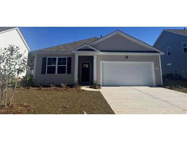 Newly constructed house with a two-car garage and well-manicured lawn at 4041 Pearl Tabby Dr., Myrtle Beach, SC 29588