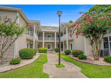 Two-story building with landscaping, offering a welcoming entrance at 1301 Sweetwater Blvd. # 1301, Murrells Inlet, SC 29576