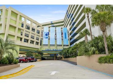 Exterior of Coral Beach Resort with parking and landscaping at 1105 S Ocean Blvd. # 1204, Myrtle Beach, SC 29572