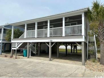 Elevated home with covered porch and parking underneath at 1521 N Waccamaw Dr., Murrells Inlet, SC 29576