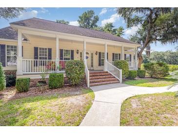 Charming one-story home with a large front porch and well-manicured lawn at 60 Wraggs Ferry Rd., Georgetown, SC 29440