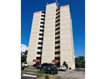 Ocean Villas building exterior, featuring multiple floors and ample parking at 7509 N Ocean Blvd., Myrtle Beach, SC 29572