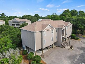 Multi-unit building with parking and surrounding trees at 194 South Cove Pl. # D, Pawleys Island, SC 29585