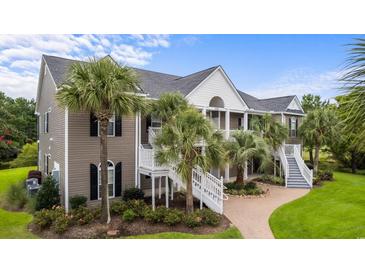 Two-story townhouse with gray siding, white trim, and a walkway at 885 Palmetto Trail # 201, Myrtle Beach, SC 29577