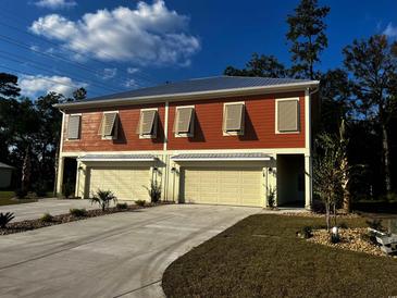 Two-unit building with attached garages and landscaping at 108 Hallandale Lane, Murrells Inlet, SC 29576