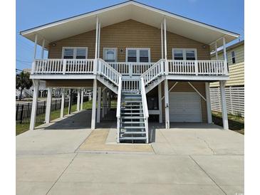 Two-story beach home with front deck and attached garage at 301 61St Ave. N, North Myrtle Beach, SC 29582