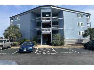 Three-story building with parking and balconies at 9540 Shore Dr. # 1-J, Myrtle Beach, SC 29572