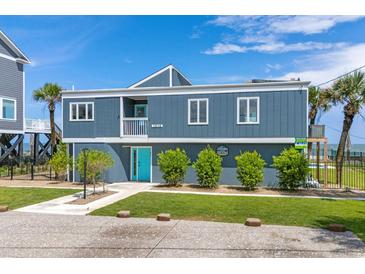 Two-story home with teal door and ocean view at 1919 South Waccamaw Dr., Garden City Beach, SC 29576