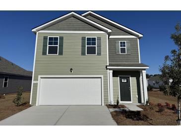 Two-story house with a neutral color scheme and a two-car garage at 170 Calm Dr., Little River, SC 29566