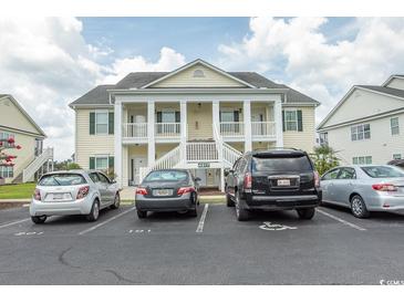 Three-story building exterior with parking in front at 4917 Twin Pond Ct. # 102, Myrtle Beach, SC 29579