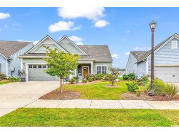 Charming one-story home with a landscaped lawn and attached garage at 6620 Pozzallo Place, Myrtle Beach, SC 29572