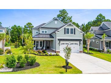 Two-story home with light green siding, a metal roof, and a landscaped lawn at 2056 Summer Rose Ln., Myrtle Beach, SC 29579