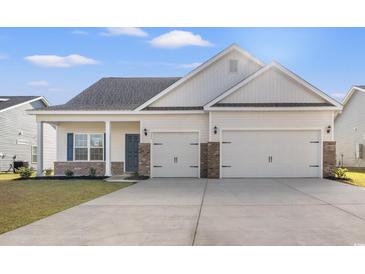 Two-story house with a two-car garage and a neatly landscaped yard at 335 Hayloft Circle, Conway, SC 29526