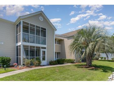 Tan siding condo building with a screened porch and landscaping at 8862 Cloister Dr. # F, Myrtle Beach, SC 29575