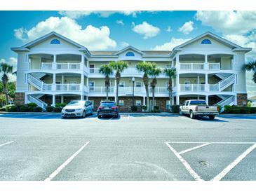 Three-story building with balconies and ample parking at 5801 Oyster Catcher Dr. # 434, North Myrtle Beach, SC 29582