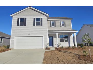 Two-story house with gray siding, white garage door, and landscaping at 193 Hadley Springs Ave, Longs, SC 29568