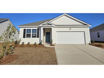 Charming one-story house with a light beige exterior, a teal front door, and a two-car garage at 201 Hadley Springs Ave, Longs, SC 29568