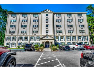 Building exterior with ample parking and landscaping at 6850 Blue Heron Blvd. # 406, Myrtle Beach, SC 29588
