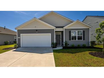 Gray and beige two-story house with a white garage door and landscaping at 238 Marauder Dr., Longs, SC 29568