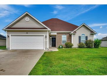 House exterior showcasing a two-car garage and well-maintained lawn at 629 Swinford Dr., Myrtle Beach, SC 29588