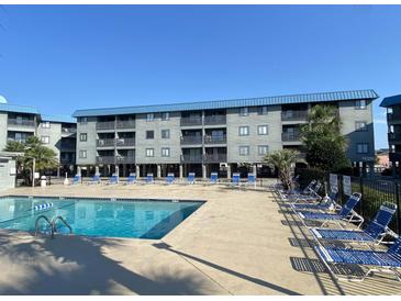 Community pool with lounge chairs, providing a relaxing outdoor space at 6000 N Ocean Blvd. # 242, North Myrtle Beach, SC 29582