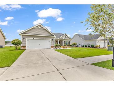 Two-story house with attached garage and manicured lawn at 1459 Tiger Grand Dr., Conway, SC 29526