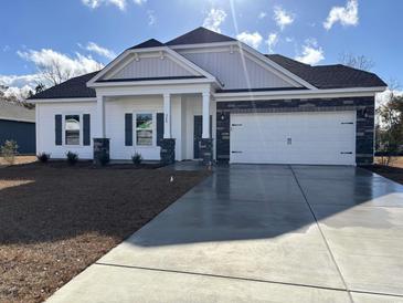 Charming new construction home with a two-car garage and covered entryway at 328 Palmetto Sand Loop, Conway, SC 29527