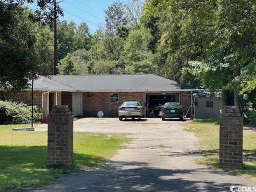 Brick ranch home with attached garage and long driveway at 695 Pendergrass Ave., Murrells Inlet, SC 29576