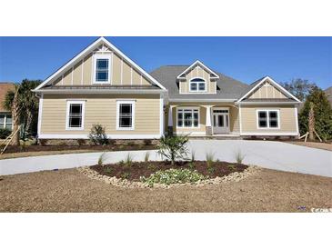 Two-story home with beige siding, stone accents, and a large driveway at 1100 Maccoa Dr., Conway, SC 29526
