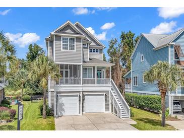 Two-story home with gray siding, two-car garage, and front porch at 6 Cottage Dr., Murrells Inlet, SC 29576