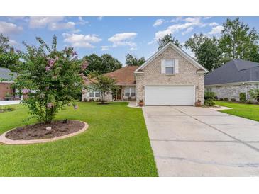 Brick house with a two-car garage and manicured lawn at 355 Foxtail Dr., Longs, SC 29568