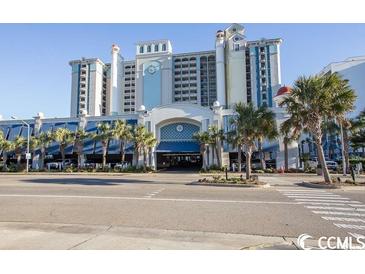 Oceanfront resort building with many balconies and palm trees at 2401 Ocean Blvd. S # 1062, Myrtle Beach, SC 29577