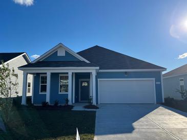 Beautiful two-story home with a light blue exterior and a two-car garage at 555 Duvall St., Longs, SC 29568